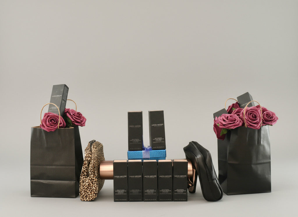 Laura Mercier foundations products on a textured surface with decorative elements